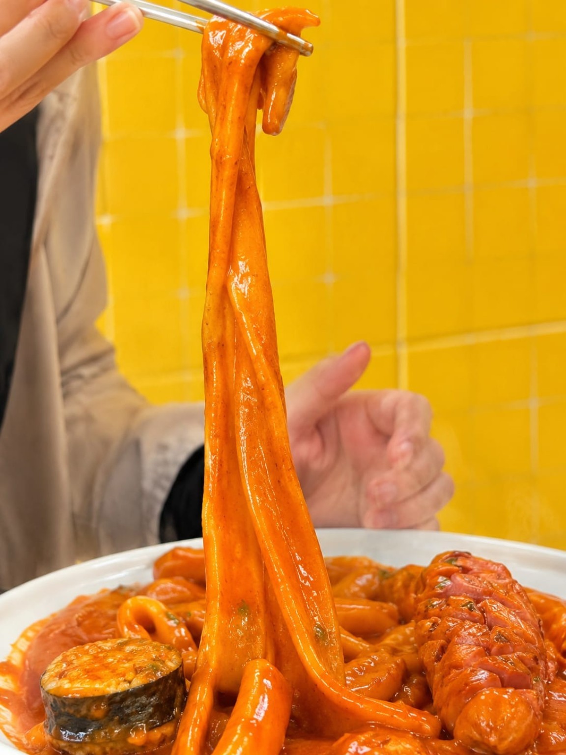 50 cm long tteokbokki being lifted high